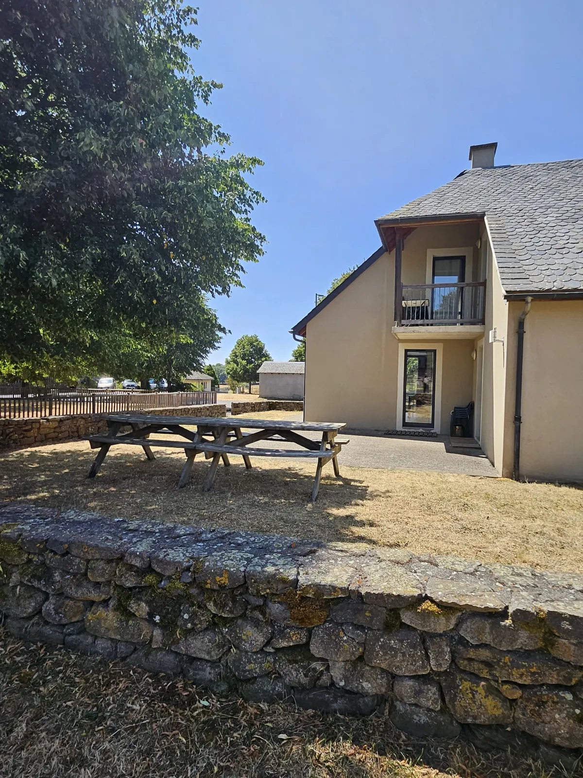 Terrasse avec table de pique-nique en bois du gîte La Pinatelle, Chalinargues